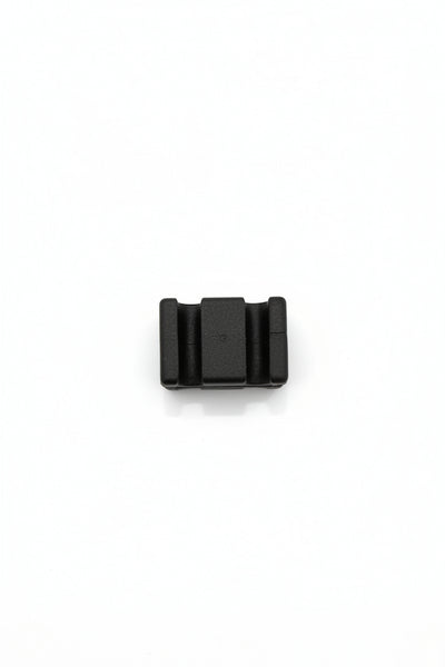 A small black plastic component or connector piece shown from above on a plain white background.