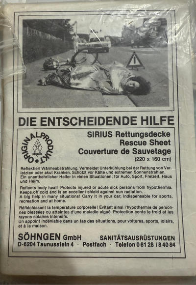Rescue sheet packaging with a photo of a person lying on the ground and text.