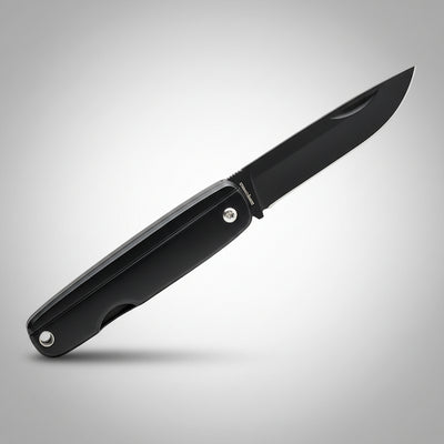 Black folding knife on a gray background