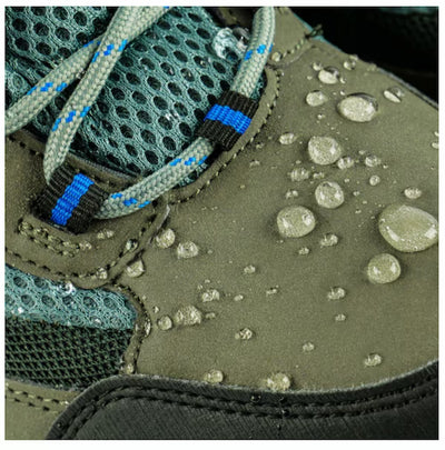Close-up of a green hiking shoe with water droplets on the surface