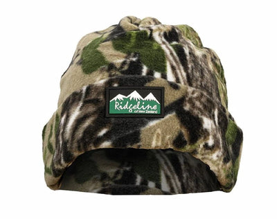 A fleece winter beanie hat in a green, brown, and black camouflage pattern, featuring a black rectangular patch on the front with a white mountain graphic and the text 'Ridgeline Outdoors of New Zealand'.