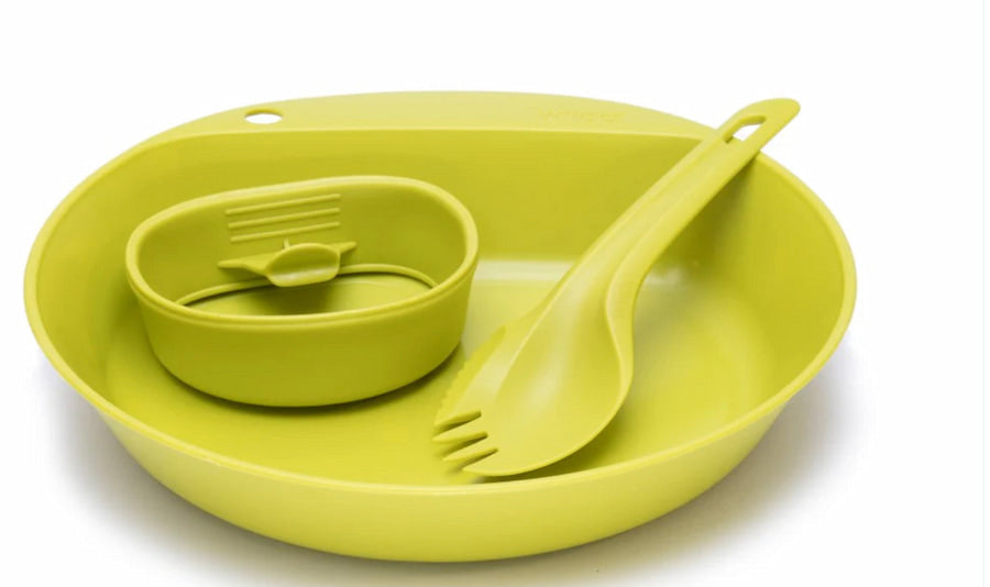 Green silicone utensil set including a bowl, spoon, and fork on a white background