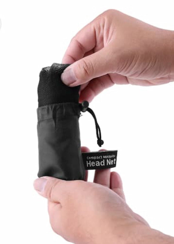 Compact head net in a drawstring bag held by hands on a white background