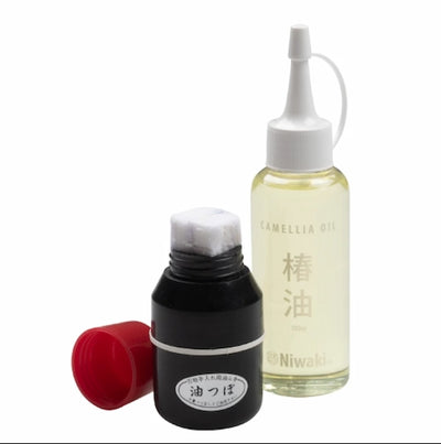 Two bottles of Niwaki Camellia Oil on a white background
