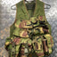 Camouflage tactical vest on a metal surface