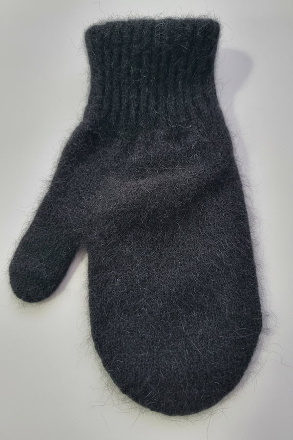 Dark gray knitted mitten on a light gray background