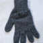 Gray knitted glove on a white background