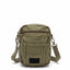 Green tactical pouch hanging on a surface with a blurred background