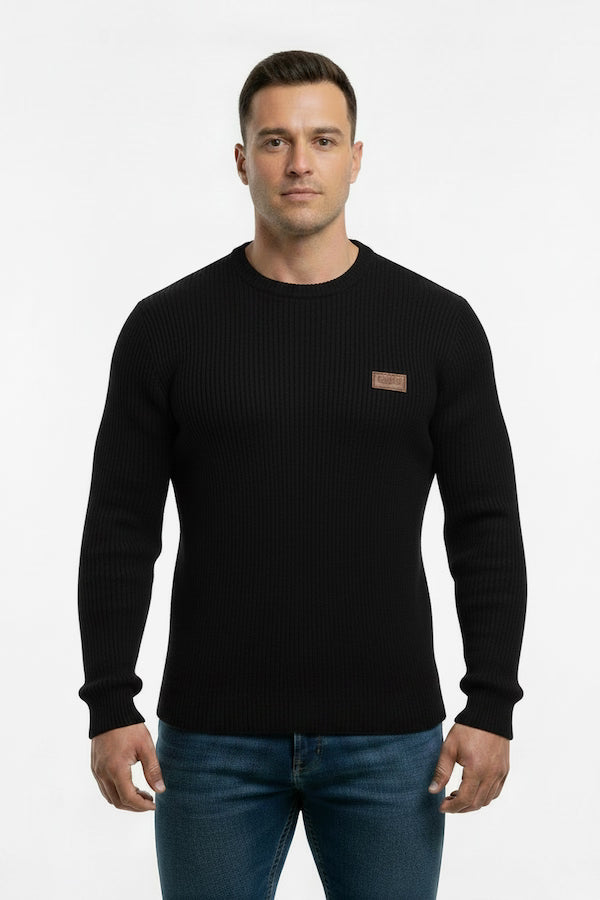 Man wearing a black sweater with a brown patch on a white background