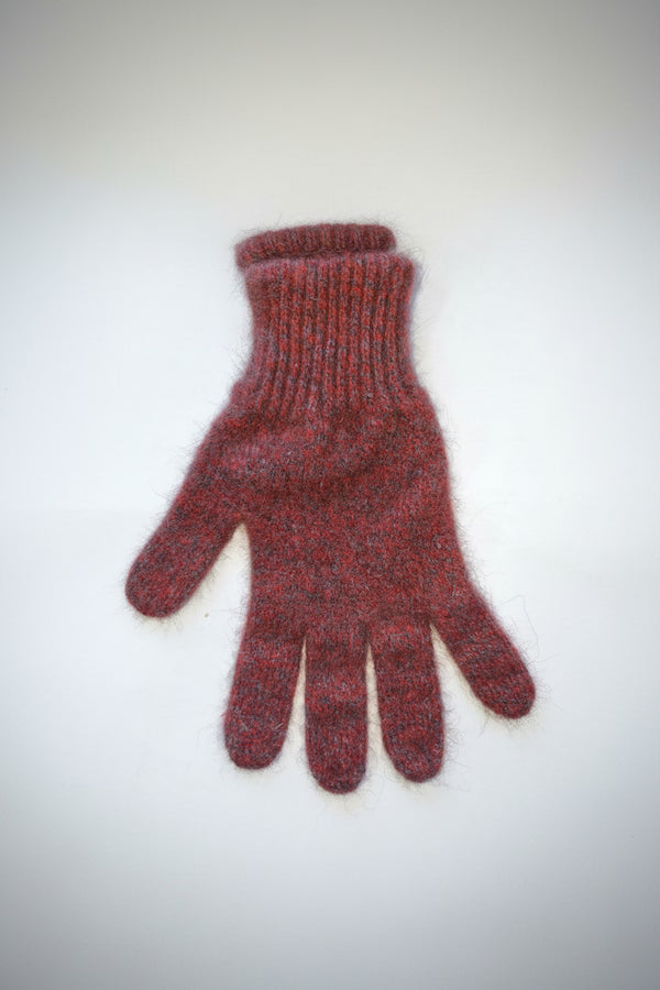 Red knitted glove on a white background