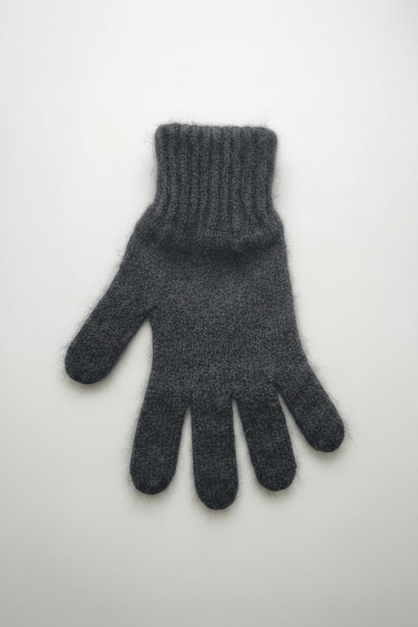 Dark gray knitted glove on a white background