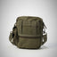 Green tactical bag on a light gray background