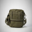 Green tactical bag on a light gray background