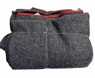 A folded dark gray wool felt blanket or throw with a contrasting red inner lining, secured with white string on a white background.