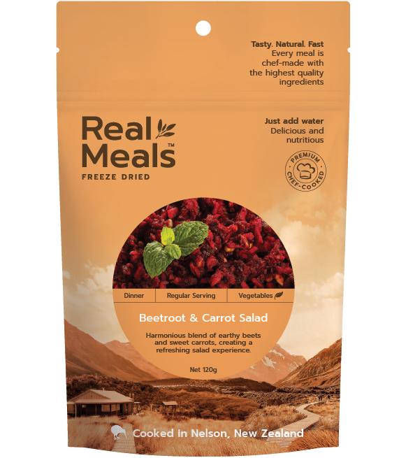 Packaging of Real Meals Freeze Dried Dinner Beetroot & Carrot Salad, with an image of the salad and a mint leaf, against a background of a landscape and mountains.
