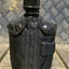 Black canteen with straps on a metallic background