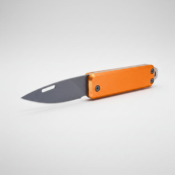Orange folding knife with a gray blade on a white background