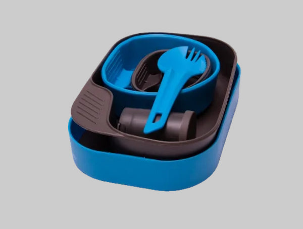 Blue and black plastic utensil set in a container on a gray background