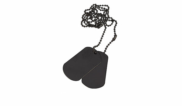 Black dog tags on a chain against a white background