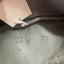 Close-up of a fabric label with 'NVA 1856 F' text on a green fabric background.