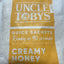 Uncle Toby's creamy honey quick sachet on a white background