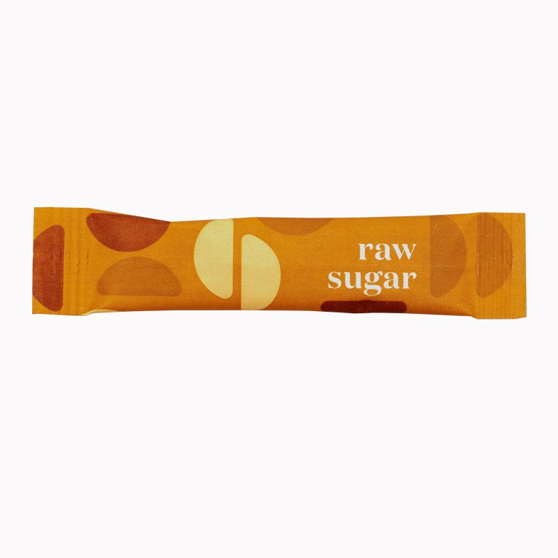 Bar of raw sugar with abstract designs on an orange background