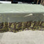 Camouflage-patterned tarp on a concrete surface