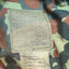 Camouflage fabric with a label on a camouflage background