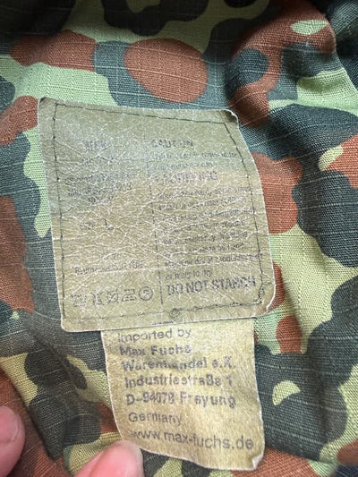 Camouflage fabric with a label on a camouflage background
