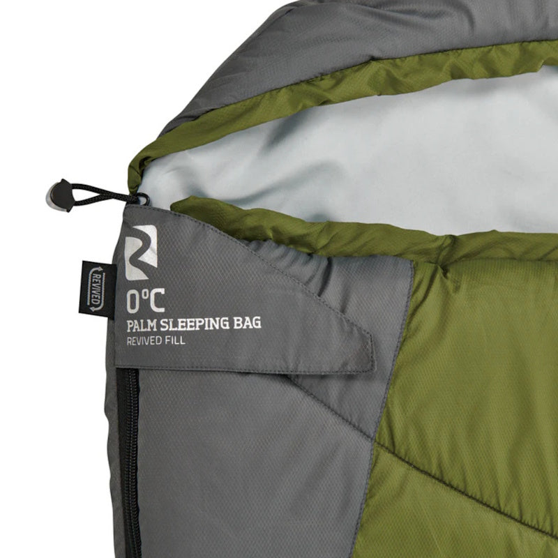Close-up of a green and gray sleeping bag with a brand label.