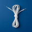 A coiled bundle of white shoelaces tied in the center, photographed flat against a solid blue background.
