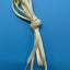 Beige shoelace tied in a knot on a blue background