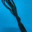 A bundle of dark green braided cord or rope tied in a knot, photographed against a solid blue background.