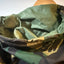 Close-up of a camouflage fabric item, likely a hood or neck warmer, showing the interior lining and pattern details.