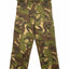 A pair of camouflage cargo pants in a classic green, brown, and tan pattern, hanging from a wooden hanger against a plain white background.