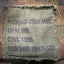 Fabric tag on a camouflage-patterned background with text and numbers.
