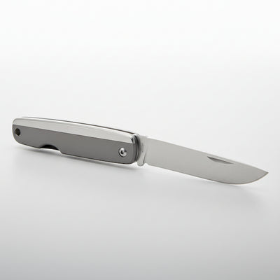 Foldable knife with metallic blade and handle on a white background