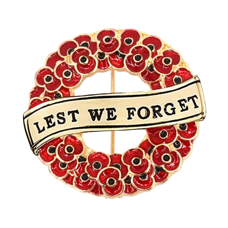 Brooch with red poppies and 'Lest We Forget' banner on a white background