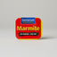 Red tin of Sanitarium Marmite on a gray background