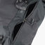 Close-up of a gray backpack with a visible brand label on a white background