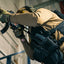 Person in tactical gear holding a weapon indoors