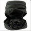 Black zippered pouch with grooming tools inside on a white background