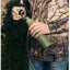 Person in camouflage holding a green water bottle outdoors