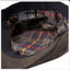 Close-up of a plaid fabric lining with care label on a dark background