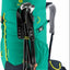 Green hiking backpack with Leki trekking poles on a white background