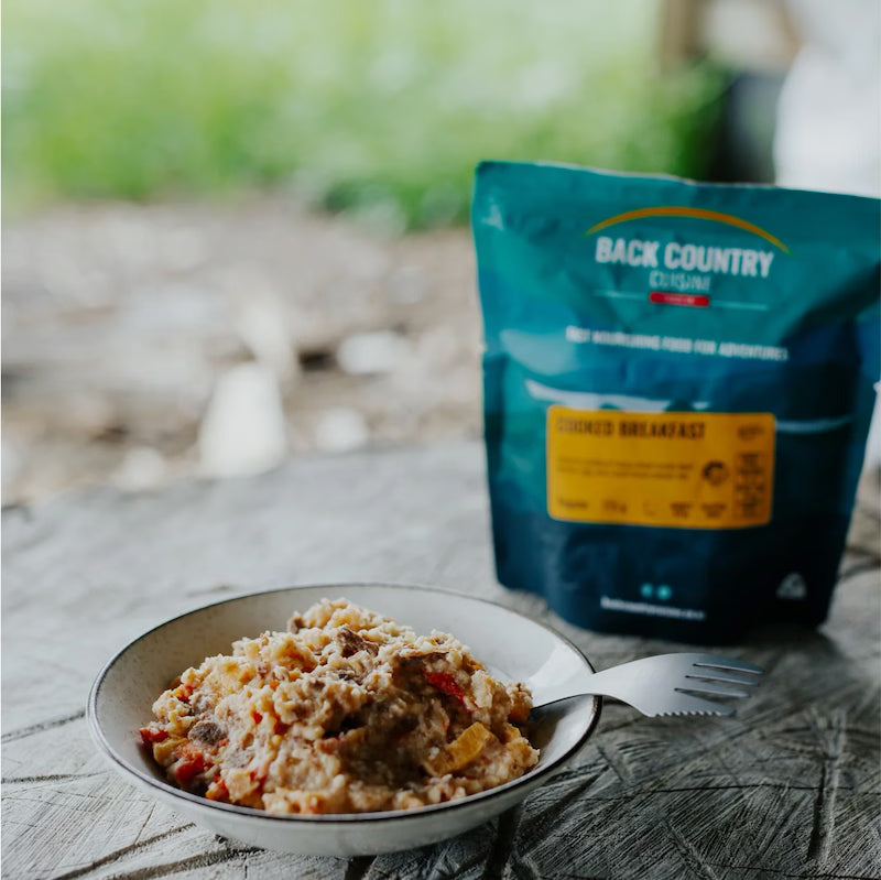 Backcountry Cuisine package with a bowl of food on a wooden surface