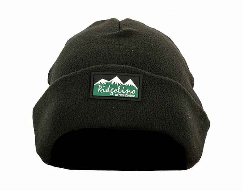 A dark olive green fleece beanie hat featuring a rectangular embroidered patch on the front with a mountain graphic and the text 'Ridgeline Co. of New Orleans'.