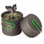 A dark gray camping pot with a matching lid, both featuring bright green handles, shown with a built-in Optifocus fuel burner. The pot has a circular logo on the front.