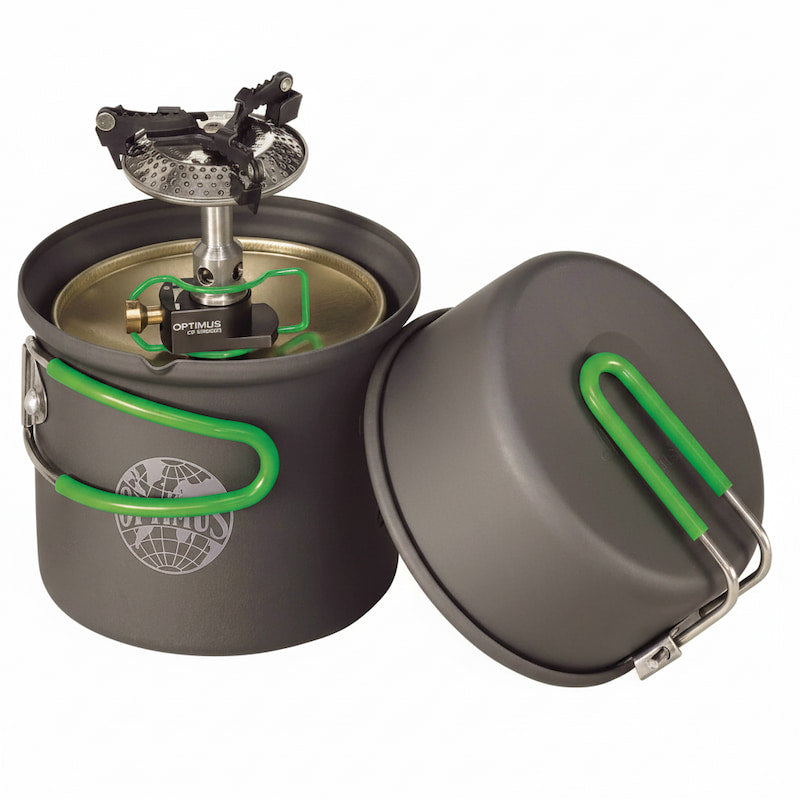 A dark gray camping pot with a matching lid, both featuring bright green handles, shown with a built-in Optifocus fuel burner. The pot has a circular logo on the front.