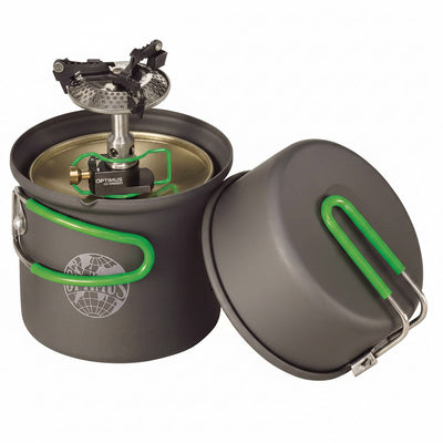 A dark gray camping pot with a matching lid, both featuring bright green handles, shown with a built-in Optifocus fuel burner. The pot has a circular logo on the front.